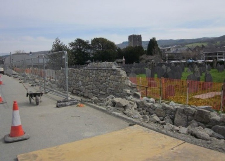 Repairing the stone wall in Dolgellau to improve the flood defences Repairing the stone wall in Dolgellau to improve the flood defences