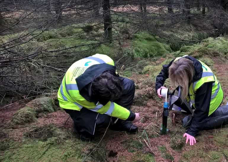 Two NRW staff members measuring the Dipwell Two NRW staff members measuring the Dipwell