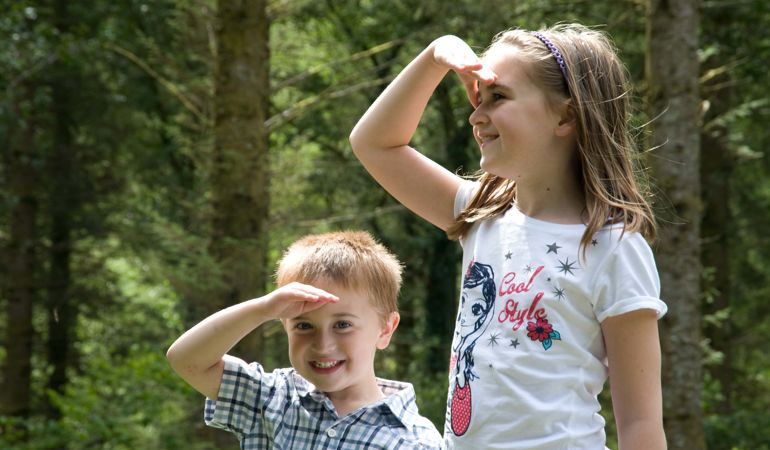 Two children with their hand hand over their eyes Two children with their hand hand over their eyes