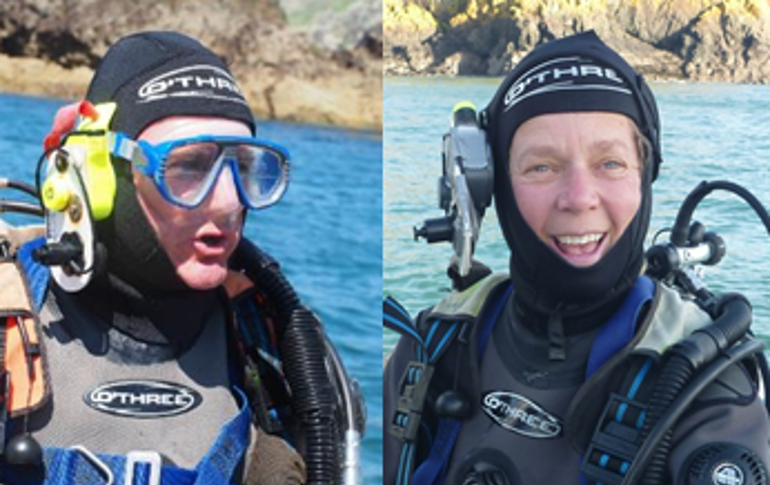 Two divers wearing full diving gear Two divers wearing full diving gear