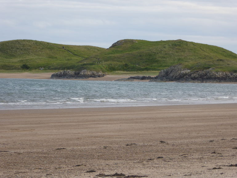 Photo showing the green landscape of Ynys Llanddwyn from Newborough beach Photo showing the green landscape of Ynys Llanddwyn from Newborough beach