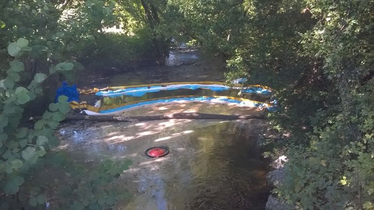 Oil spill in a river Oil spill in a river