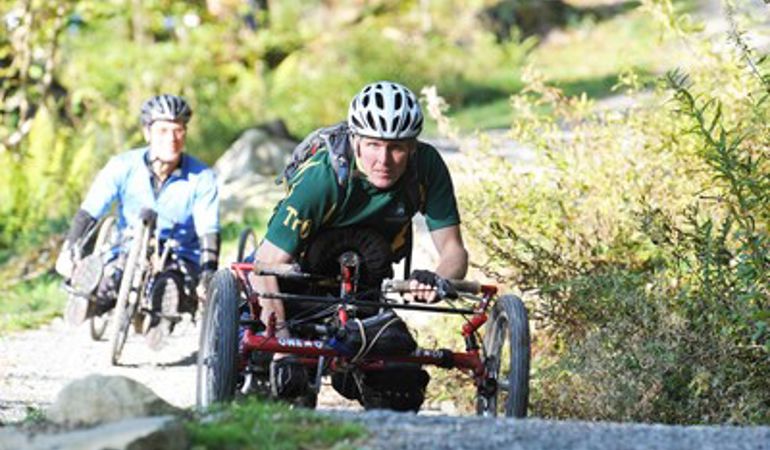 Two people using their bikes on a trail Two people using their bikes on a trail