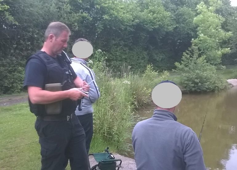 NRW enforcement officer checking rod licences NRW enforcement officer checking rod licences