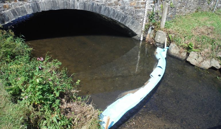 Image of a boom that has been deployed on the Tawelon Brook, near Johnstown in Carmarthenshire Image of a boom that has been deployed on the Tawelon Brook, near Johnstown in Carmarthenshire
