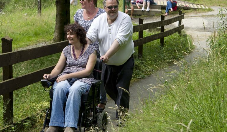 A group of people on an accessible trail A group of people on an accessible trail