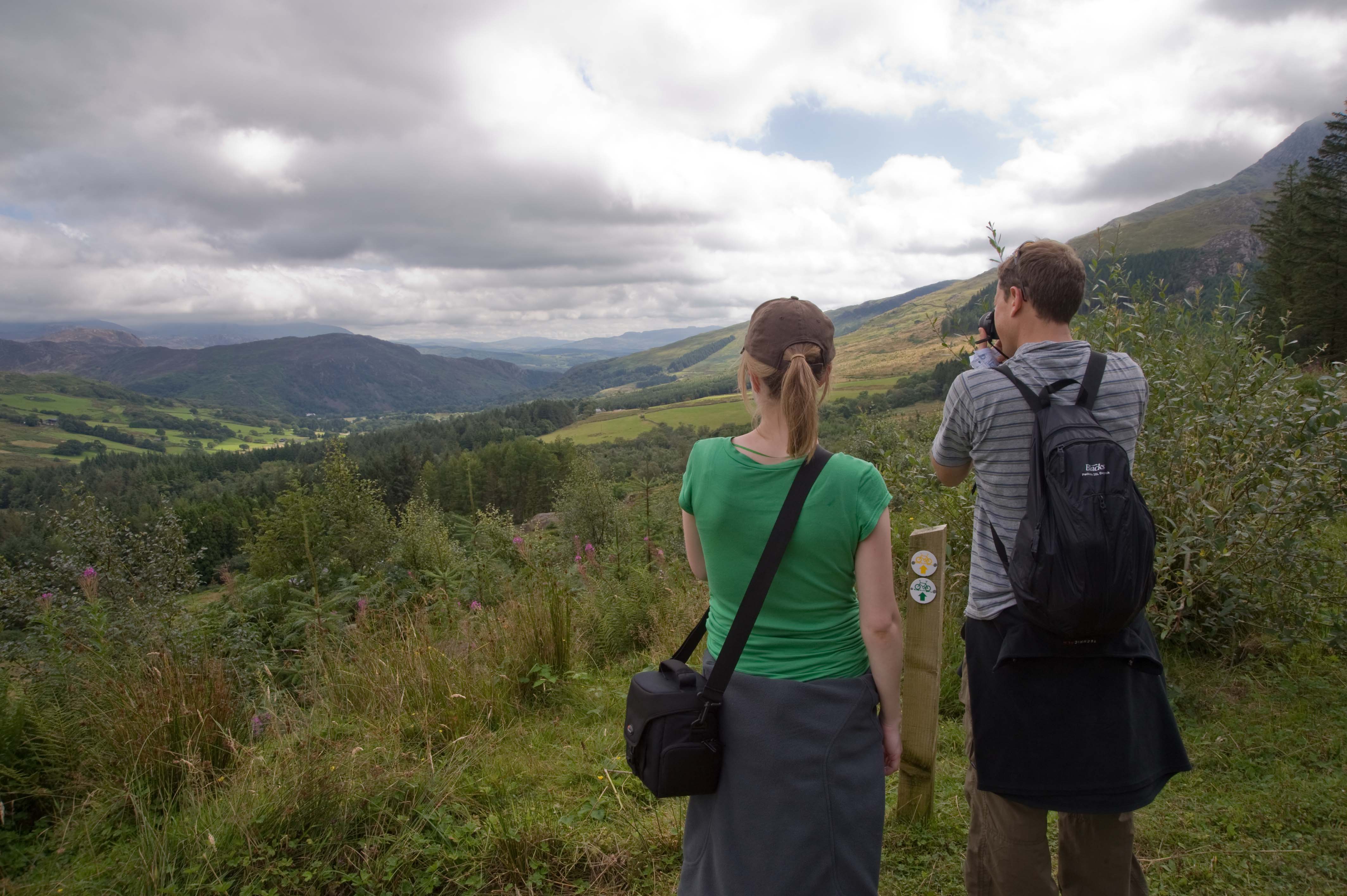 Man and woman looking at view of mountains