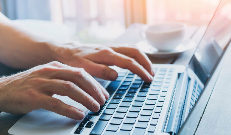 Image on hands typing on laptop Image on hands typing on laptop